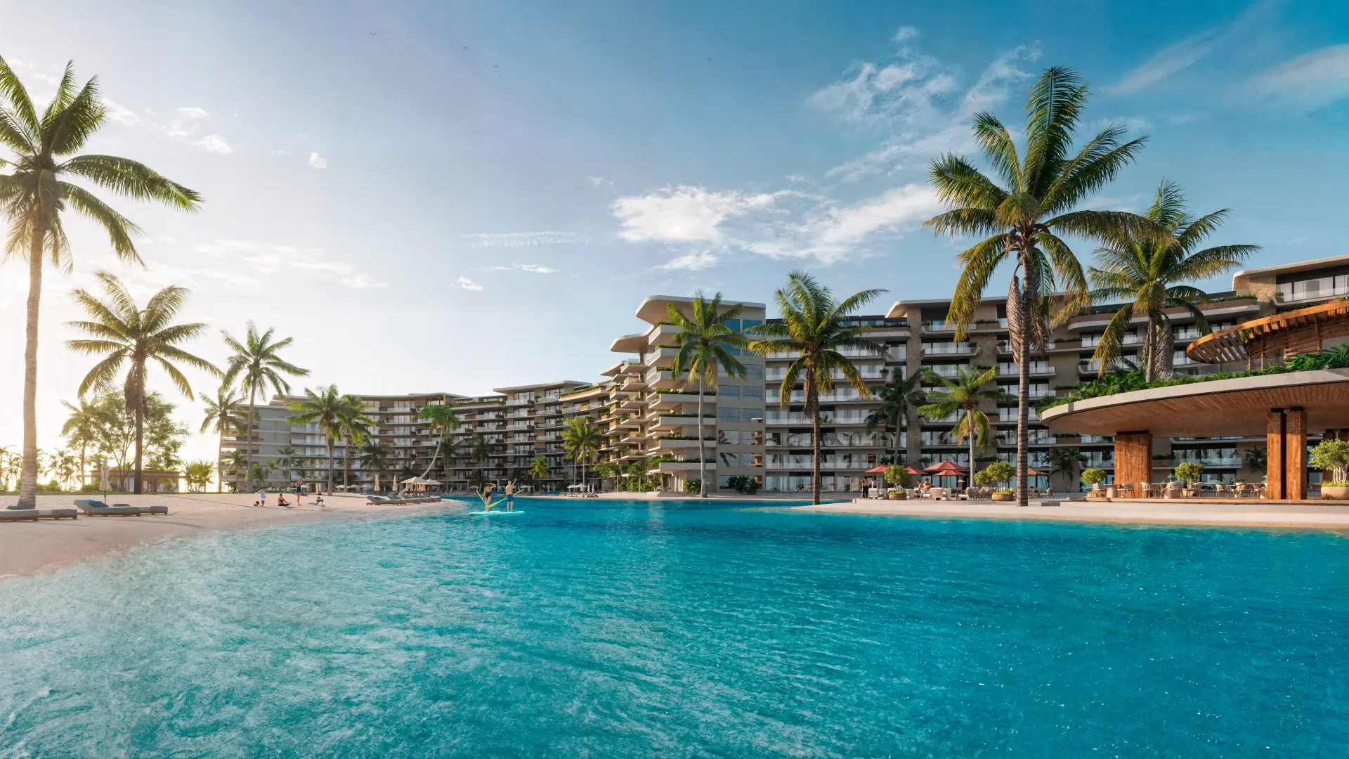 La lagune de Bonita Beach dans une lumière chaude, des palmiers le long de l’eau et les résidences courbes avec leur terrasse en bois.