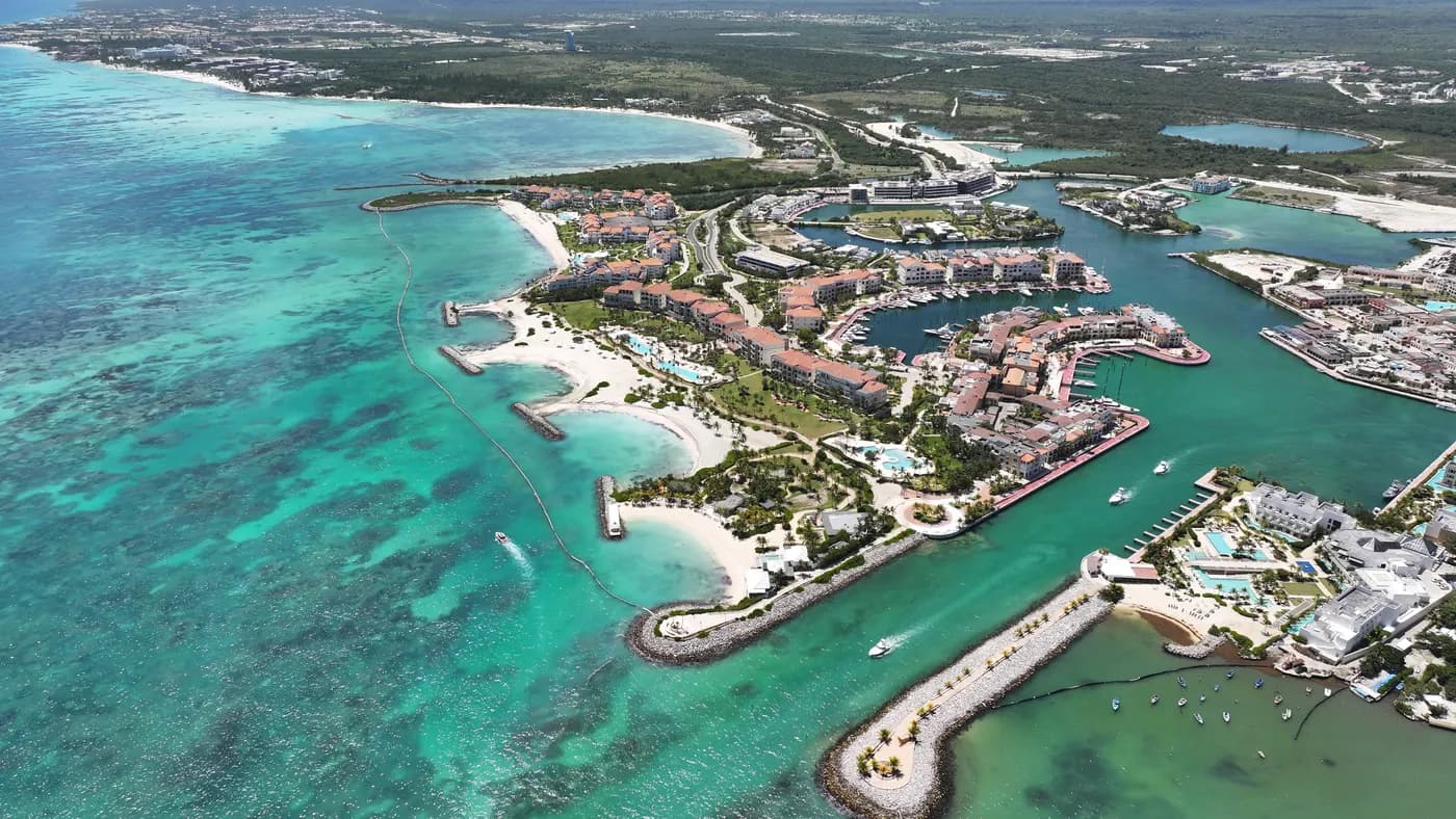 Real aerial photograph of Marina Cap Cana: the inlet, the slips and the village around the turquoise channels.