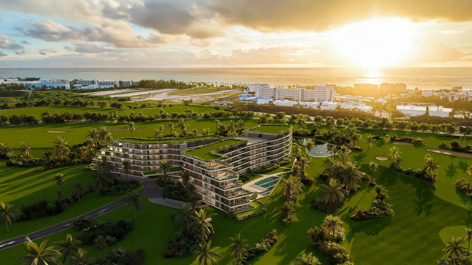 Aerial view of the Bonita Golf building among the fairways, with the sea on the horizon and the sun low.