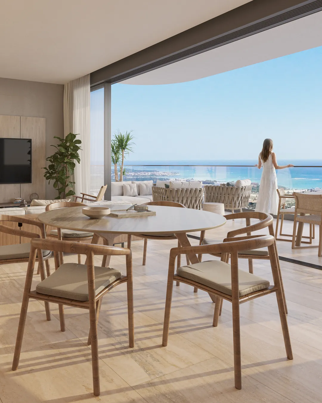 Le séjour d'une résidence de deux chambres à Bonita Beach : la table à manger contre la baie vitrée, la lagune et la mer loin en contrebas du balcon.